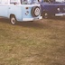 picture of three vans parked on grass